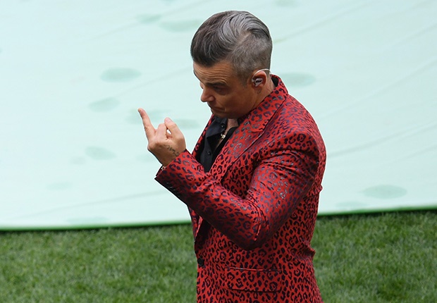 MOSCOW, RUSSIA - JUNE 14:  (EDITORS NOTE: Image contains profanity.) Singer Robbie Williams gestures into a TV camera during the opening ceremony prior to the 2018 FIFA World Cup Russia Group A match between Russia and Saudi Arabia at Luzhniki Stadium on June 14, 2018 in Moscow, Russia.  (Photo by Shaun Botterill/Getty Images)