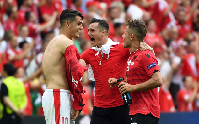 Switzerland's Granit Xhaka, left, talks with his brother, Albania's Taulant Xhaka, and Albania's Amir Abrashi, right, at the end of the Euro 2016 Group A soccer match between Albania and Switzerland, at the Bollaert stadium in Lens, France, Saturday, June 11, 2016. (AP Photo/Geert Vanden Wijngaert)