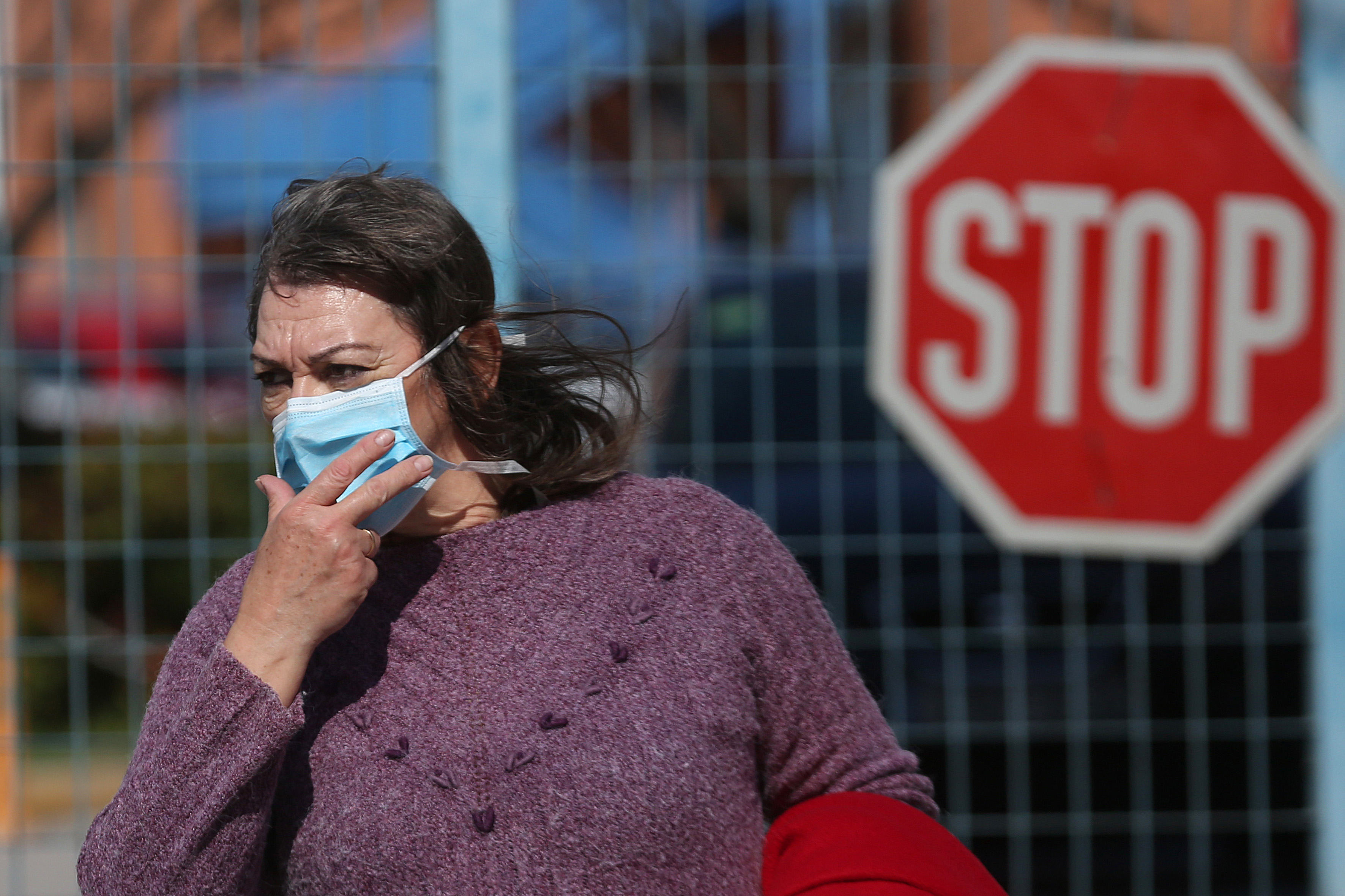 Mandatory Credit: Photo by ORESTIS PANAGIOTOU/EPA-EFE/Shutterstock (10568781d) A woman wears a protective face mask as she exits Attiko hospital, where the first confirmed, in Athens and the third in Greece coronavirus COVID-19 case is being treated, in Athens, Greece, 27 February 2020. The first coronavirus case in Athens is confirmed, Greece - 27 Feb 2020