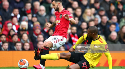 MANCHESTER, ENGLAND - FEBRUARY 23: Christian Kabasele of Watford tackles Bruno Fernandes of Manchester United during the Premier League match between Manchester United and Watford FC at Old Trafford on February 23, 2020 in Manchester, United Kingdom. (Photo by Clive Brunskill/Getty Images)
