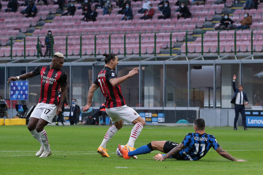 Zlatan Ibrahimovic of AC Milan is fouled by Aleksandar Kolarov of Internazionale in the penalty area for AC Milan to be