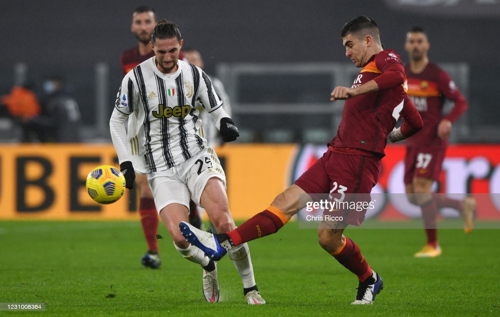 TURIN, ITALY - FEBRUARY 06: Adrien Rabiot of Juventus challenged by Gianluca Mancini of AS Roma during the Serie A match between Juventus and AS Roma at Allianz Stadium on February 6, 2021 in Turin, Italy. Sporting stadiums around Italy remain under strict restrictions due to the Coronavirus Pandemic as Government social distancing laws prohibit fans inside venues resulting in games being played behind closed doors. (Photo by Chris Ricco/Getty Images)
