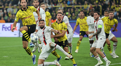 DORTMUND, GERMANY - OCTOBER 04: Ramy Bensebaini of Borussia Dortmund and Olivier Giroud of AC Milan battle for possession during the UEFA Champions League match between Borussia Dortmund and AC Milan at Signal Iduna Park on October 04, 2023 in Dortmund, Germany. (Photo by Christof Koepsel/Getty Images)