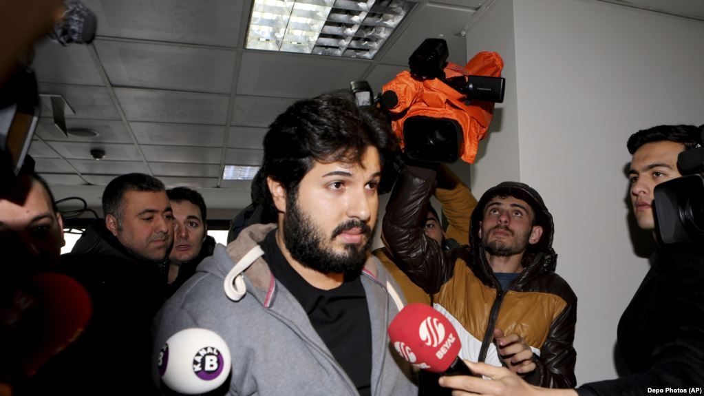 FILE-In this Tuesday, Dec. 17, 2013 file photo, Turkish-Iranian businessman Reza Zarrab, who is charged currently in the U.S. for evading sanctions on Iran, is surrounded by the media members as he arrives at a courthouse in Istanbul,in a separate case against him. Turkey's Deputy Prime Minister Bekir Bozdag on Monday, Nov. 20, 2017 depicted an upcoming trial in the United States against Zarrab, the main defendant, as a "conspiracy" against Turkey and also described him AS a "hostage" who he claimed was being forced to testify against Turkey's government. Trial begins in New York on Nov. 27. (Depo Photos via AP, File)