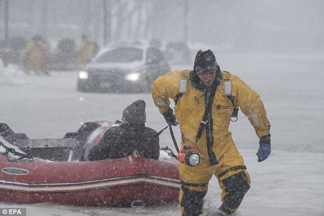 47C24B9400000578-5239217-Firefighter_Justin_Plaza_pulls_a_rescued_motorist_to_dry_land_in-a-24_1515164222054