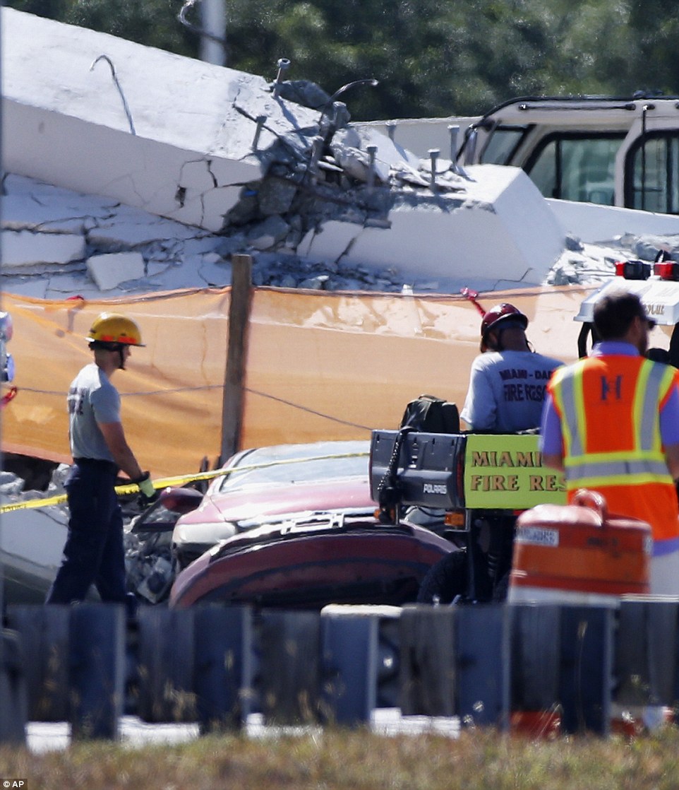 4A3AF82700000578-5506597-Rescue_workers_approach_the_crushed_car_after_the_bridge_s_colla-a-9_1521171836922