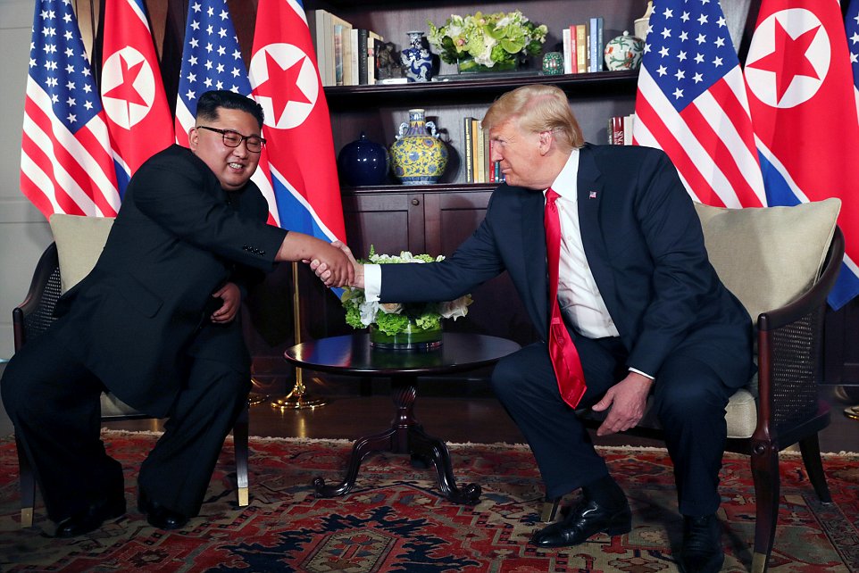 U.S. President Donald Trump shakes hands with North Korea's leader Kim Jong Un before their bilateral meeting at the Capella Hotel on Sentosa island in Singapore June 12, 2018. REUTERS/Jonathan Ernst