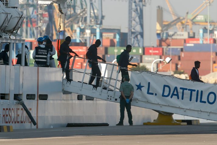 Migrants disembark from the Italian coast guard boat the Dattilo at the port of Valencia on June 17, 2018. - The first migrants from the Aquarius, which was turned away by Italy and Malta sparking a major migration row in Europe, disembarked in the Spanish port of Valencia. The others will arrive an Italian navy ship, the Orione, and the Aquarius itself by noon, regional authorities said. (Photo by PAU BARRENA / AFP) (Photo credit should read PAU BARRENA/AFP/Getty Images)