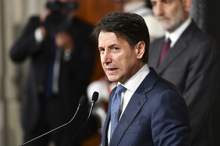 Italian lawyer Giuseppe Conte addresses journalists after a meeting with Italy's President Sergio Mattarella on May 23, 2018 at the Quirinale presidential palace in Rome. Italy's president approved little-known lawyer Giuseppe Conte's nomination to be prime minister of a government formed by far-right and anti-establishment parties. / AFP PHOTO / Vincenzo PINTO