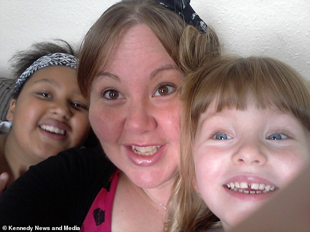 PIC FROM Kennedy News and Media (PICTURED: LAURA CISSE, 38, WITH DAUGHTERS AYESHA, 15, AND SOPHIE, 7) A mum believes a ghostly little girl she caught on camera could be a 'future echo' of her daughter - in a photo she took three years BEFORE the child was born. Laura Cisse, 38, spotted the eerie figure standing behind her 15-year-old daughter Ayesha in a photo taken 10 years ago for the first time last week. The mum-of-two mistook the girl for her youngest daughter Sophie as she looks very similar and has blonde hair - before realising Sophie wasn't even born when it was taken. SEE KENNEDY NEWS COPY - 0161 660 8596