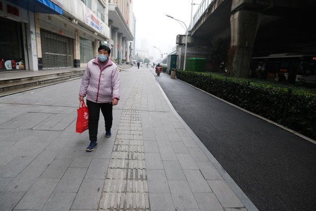 A-few-residents-ventured-outdoors-wearing-protective-face-masks-as-officials-advised-against-travel-in-and-out-of-the-city