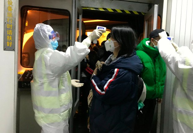 Health-Officials-in-hazmat-suits-check-body-temperatures-of-passengers-arriving-from-the-city-of-Wuhan
