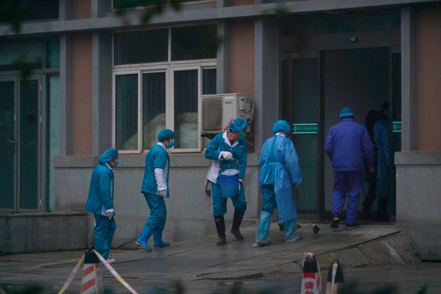 Hospital-staff-wash-the-emergency-entrance-of-Wuhan-Medical-Treatment-Center-where-some-infected-with-a-new-virus-are-being-treated