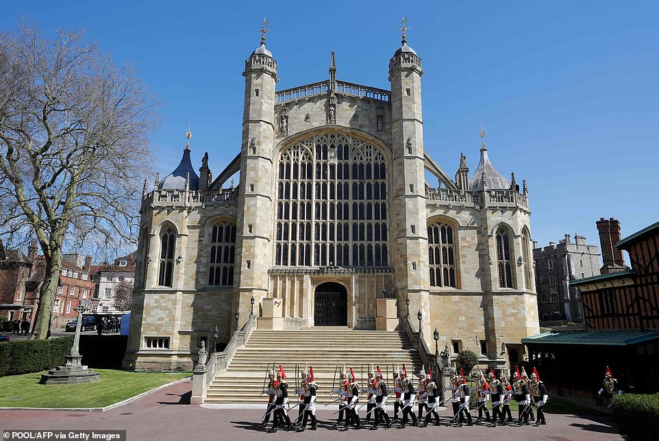 41871260-9481659-Members_of_the_Household_Cavalry_march_past_St_George_s_Chapel_w-m-228_1618663388447