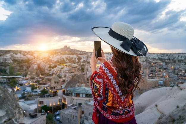 woman-take-photo-with-her-smartphone-goreme-cappadocia-turkey_335224-562