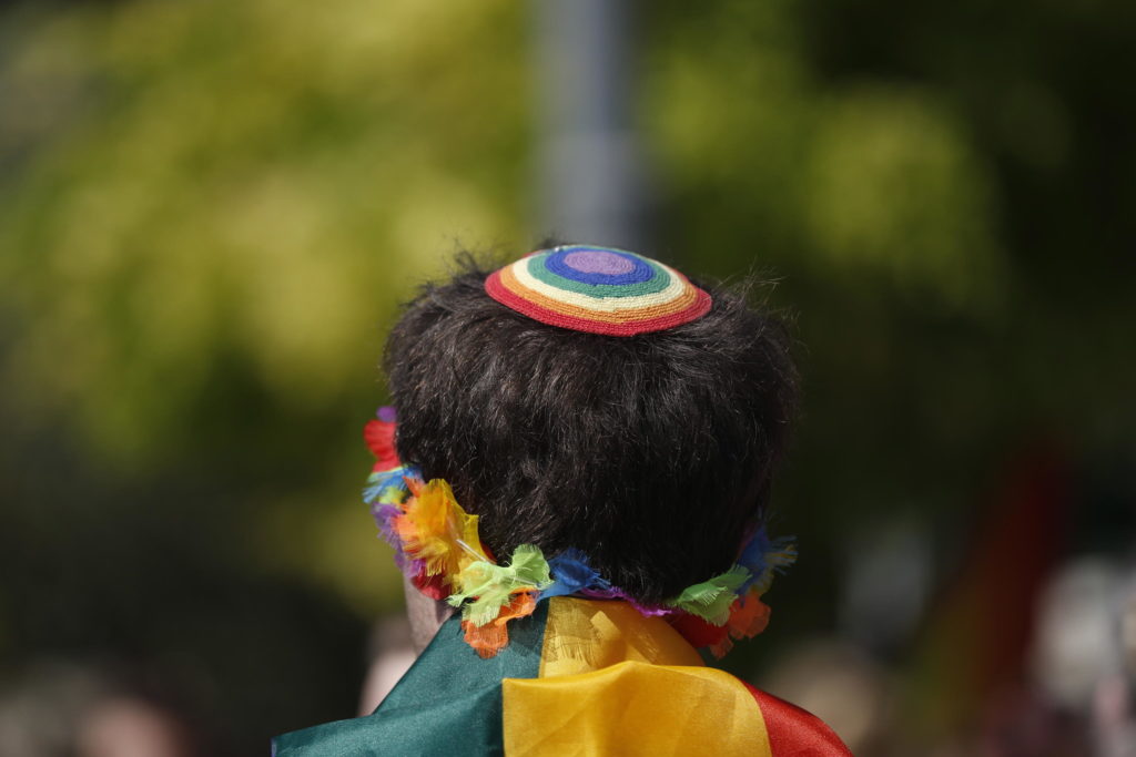 epa09245492 A person wears a rainbow-colored Kippah as members and supporters of the LGBTI (lesbian, gay, bisexual, transgender, and intersex) community participate in the annual Jerusalem March for Pride and Tolerance, in Jerusalem, Israel, 03 June 2021. Thousands of people took part in the event organized by the Jerusalem Open House for Pride and Tolerance, held under heavy police security. EPA/ATEF SAFADI