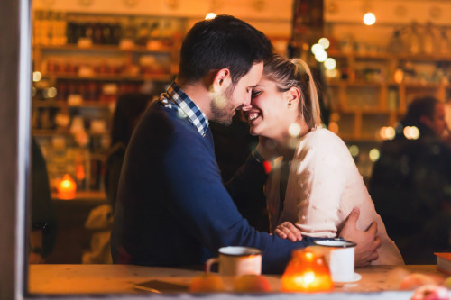 happy-couple-kissing-at-bar-and-having-date-royalty-free-image-1583341969