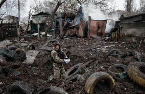 A police officer inspects a hole after a rocket strike, in Kramatorsk on February 2, 2023, amid the Russian invasion of Ukraine. - At least three people were killed on February 2, 2023, and 20 wounded when a Russian rocket struck a residential building in the centre of Kramatorsk, located in Ukraine's eastern industrial region of Donetsk. (Photo by YASUYOSHI CHIBA / AFP) (Photo by YASUYOSHI CHIBA/AFP via Getty Images)