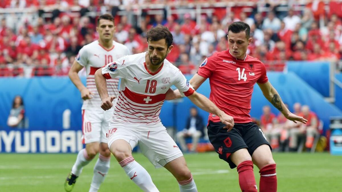 Switzerland's forward Admir Mehmedi (L) and Albania's midfielder Taulant Xhaka vie for the ball during the Euro 2016 group A football match between Albania and Switzerland at the Bollaert-Delelis Stadium in Lens on June 11, 2016. / AFP / PHILIPPE HUGUEN