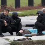 A gunman with an automatic weapon, lies on a street after being overwhelmed after he fired shots at the U.S. Embassy, in Sarajevo