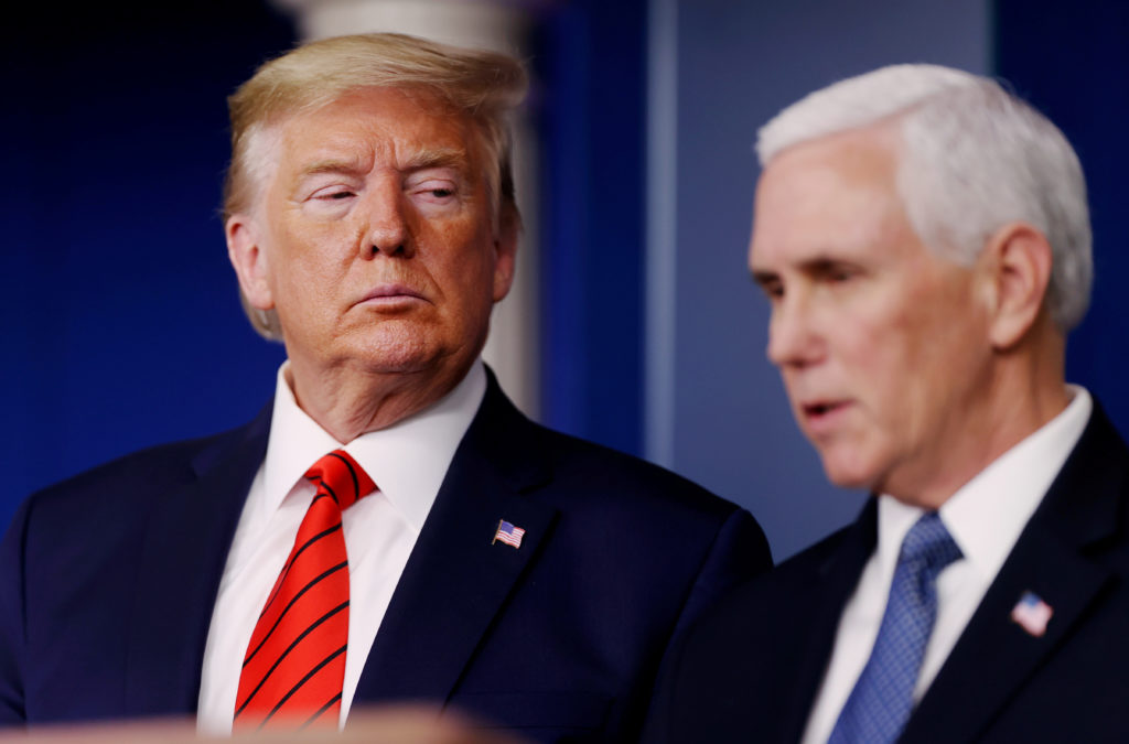 U.S. President Donald Trump listens to Vice President Mike Pence address the coronavirus response daily briefing at the White House in Washington, U.S., March 19, 2020. REUTERS/Jonathan Ernst