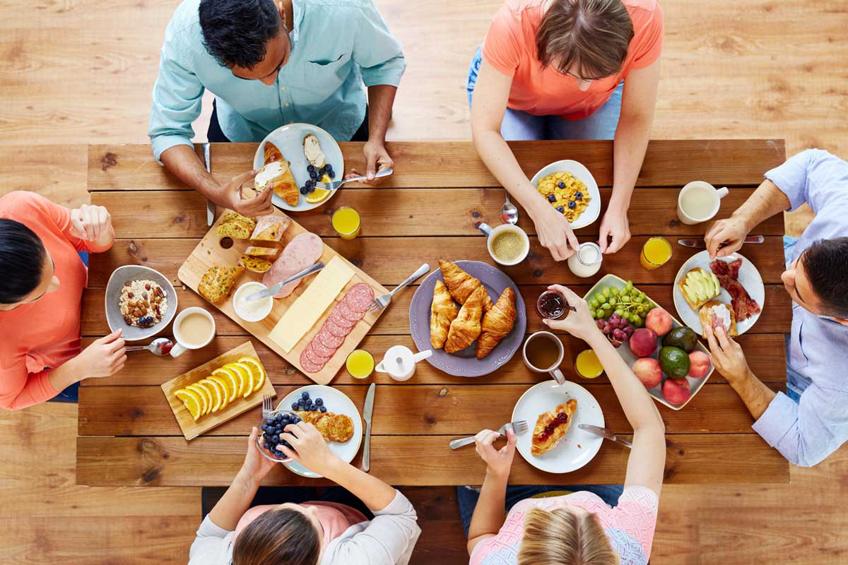group of people having breakfast at table