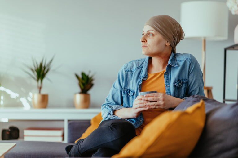 Cancer patient looking far, wearing headscarf